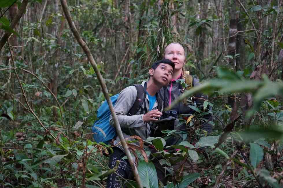 Woman and assistant in Borneo jungle